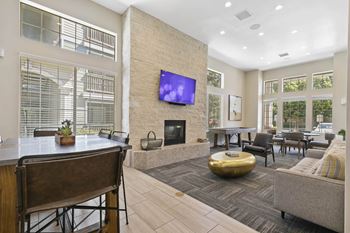 A living room with a fireplace and a table with chairs